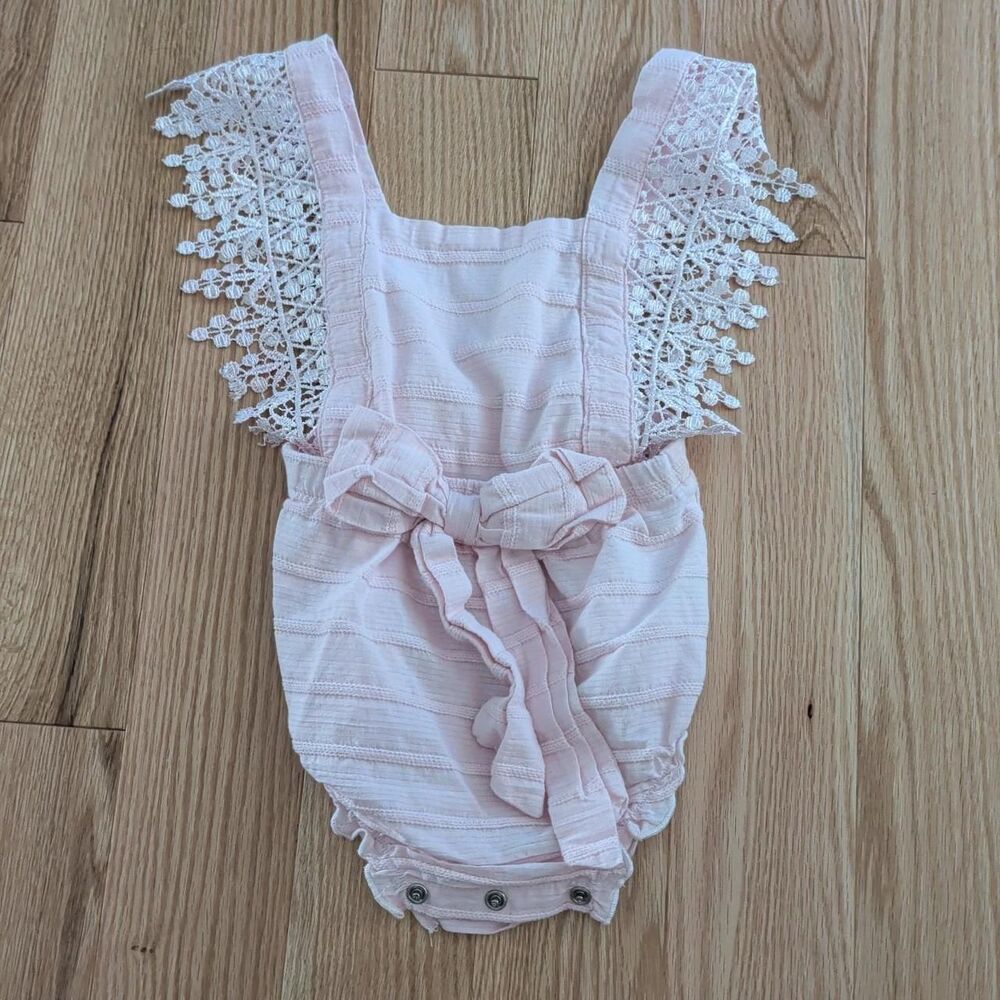 Pink baby romper with pink lace trim
